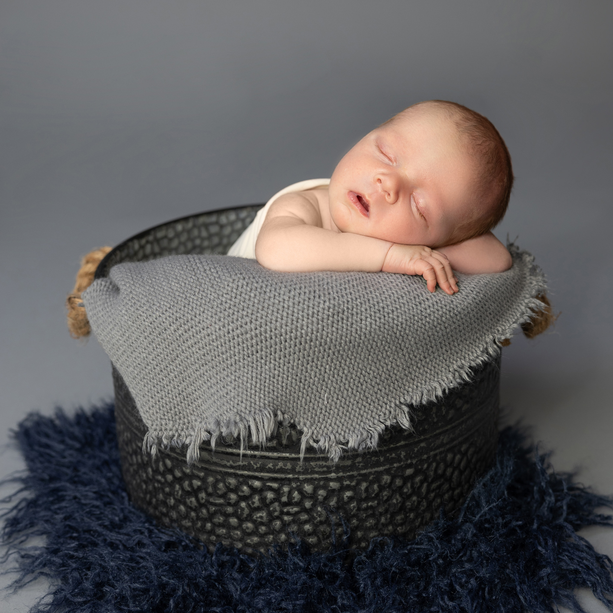 newborn baby photography baby in a bucket